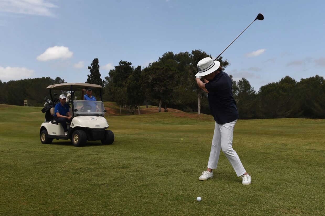 man playing golf about to hit his ball in the gold course