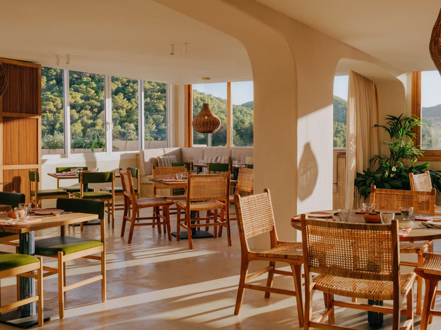 inside of Cuyo restaurant with a couple of empty tables and chairs