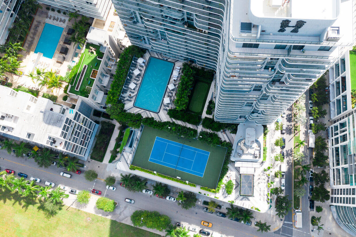 Ariel view - Facade of Hyde Midtown Miami with shots of the tennis court and pool