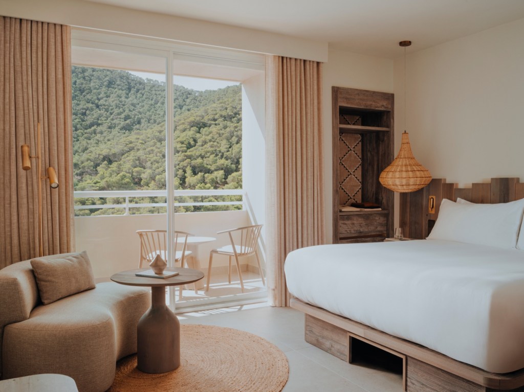 bedroom at Hyde Ibiza with large bed, big windows and sofa